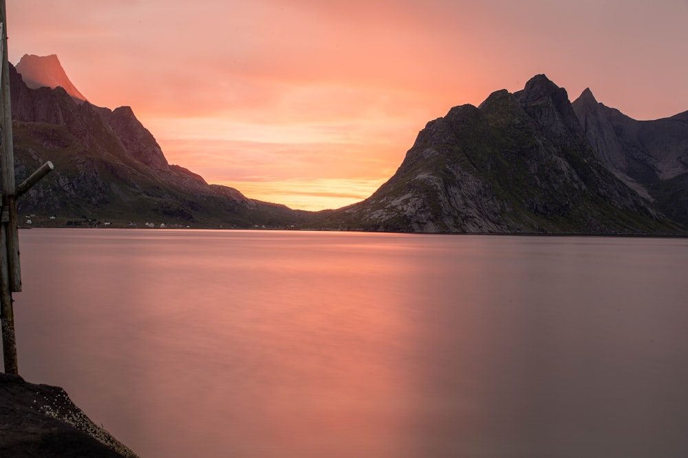 a body of water with mountains in the background