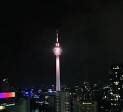 A vibrant cityscape at dusk with Verizon towers glowing, symbolizing strong network coverage.