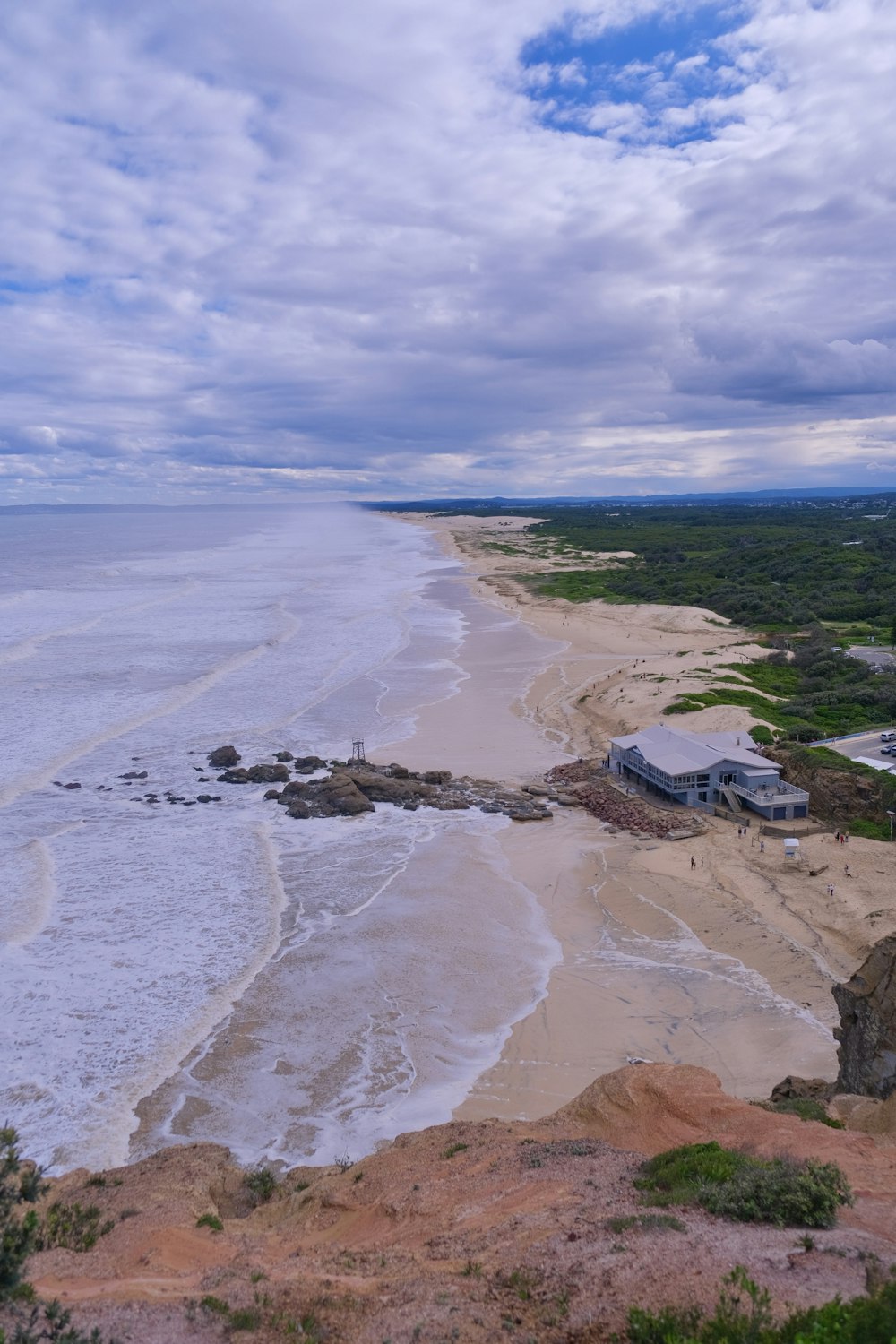 a beach with a house on it