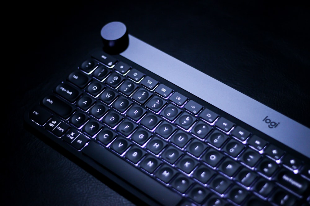 a black keyboard with a small white bottle on top