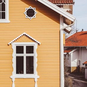 a yellow house with a red roof