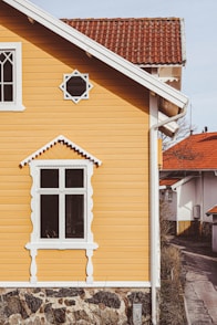 a yellow house with a red roof