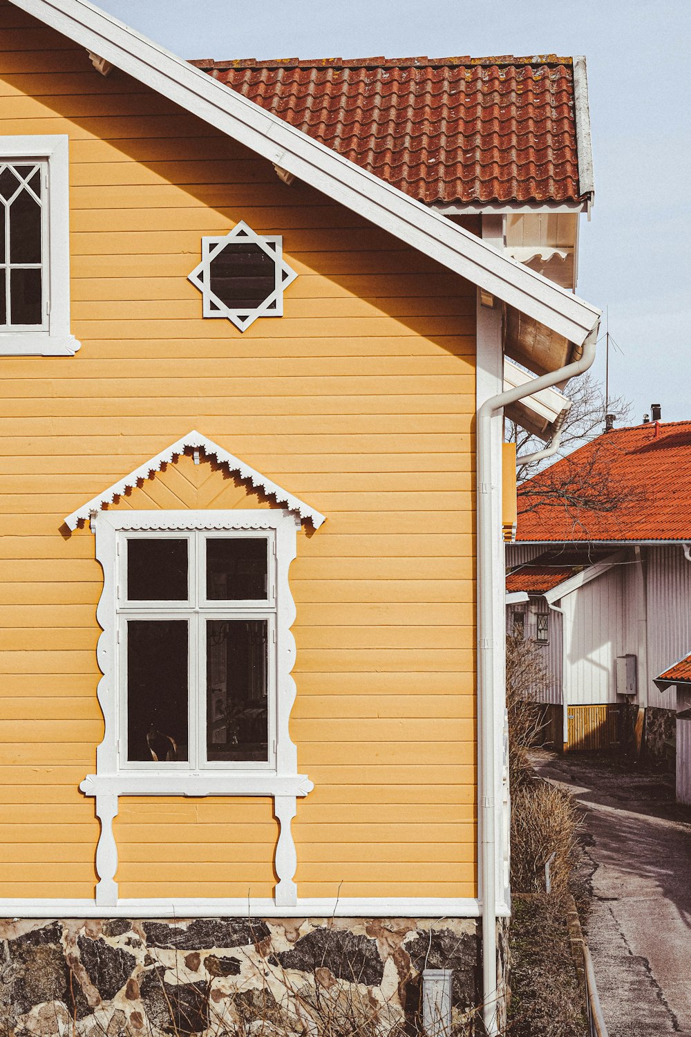 a yellow house with a red roof