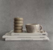 a stack of books and a cup