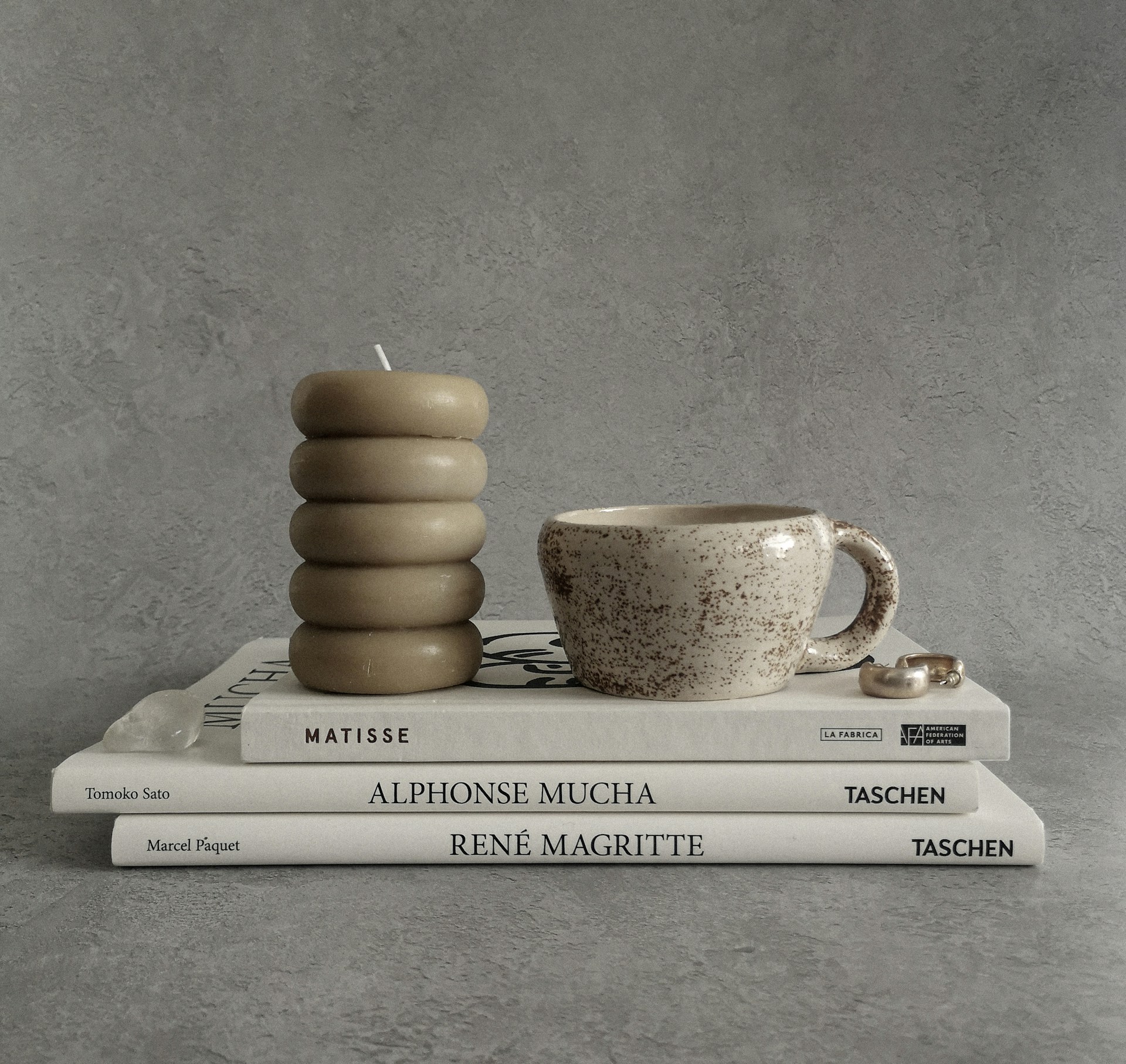 a stack of books and a cup