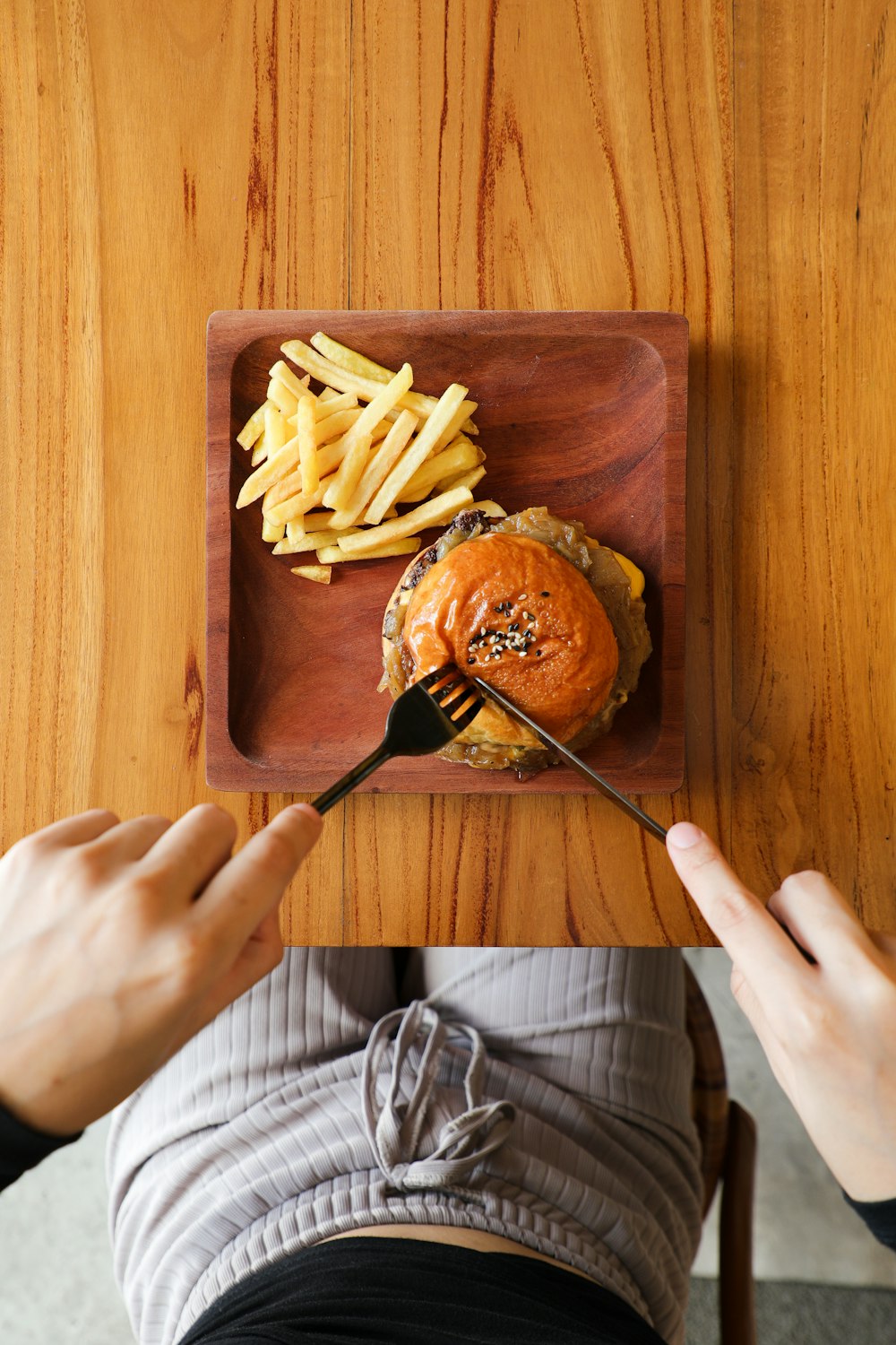 a person holding a fork and a plate of food