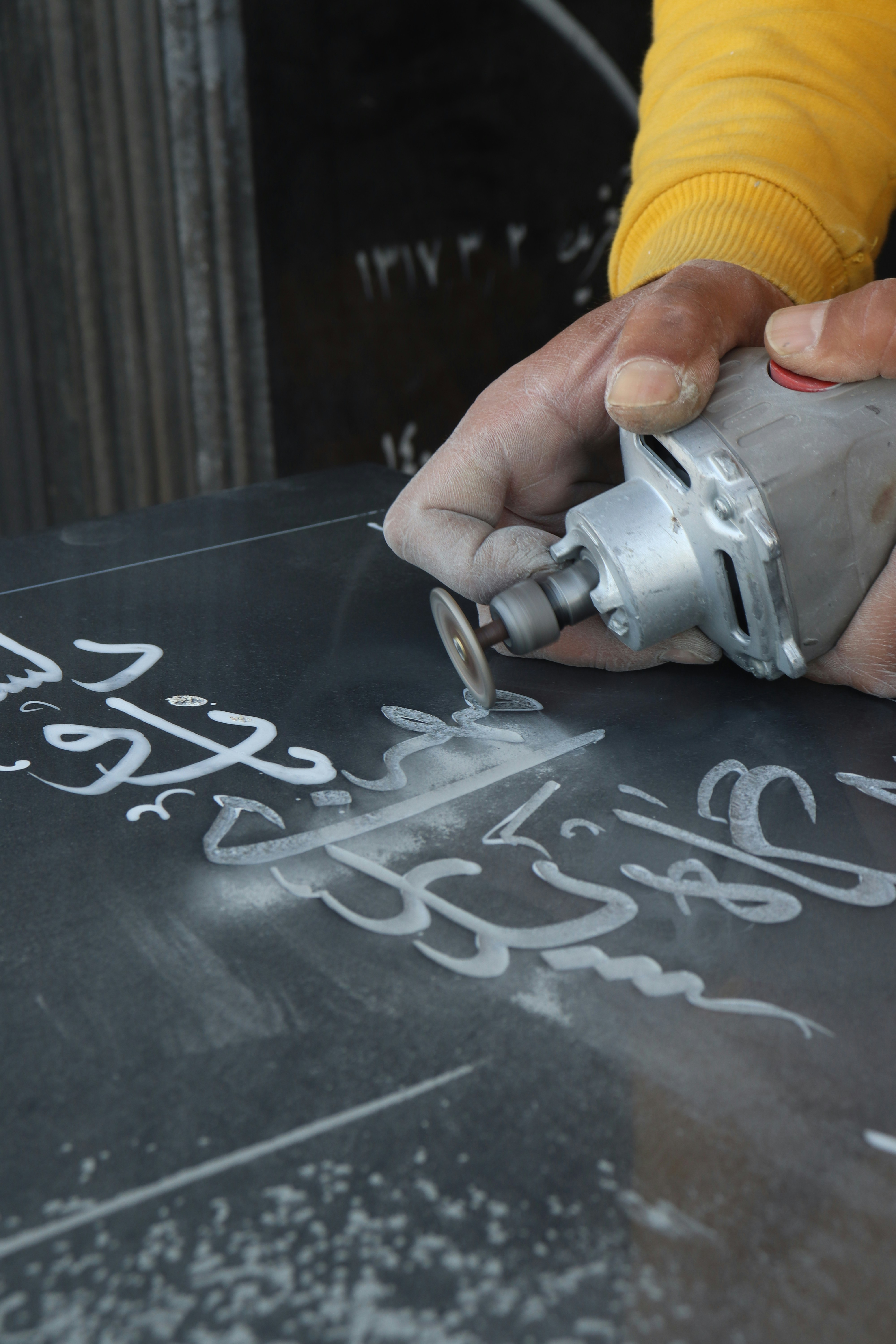 a person writing on a chalkboard