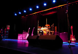 a stage with a set of musical instruments and a microphone
