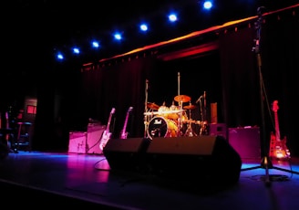 a stage with a set of musical instruments and a microphone