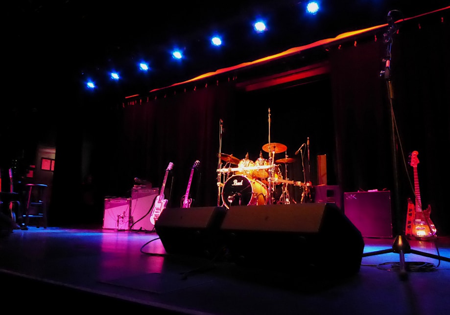 a stage with a set of musical instruments and a microphone