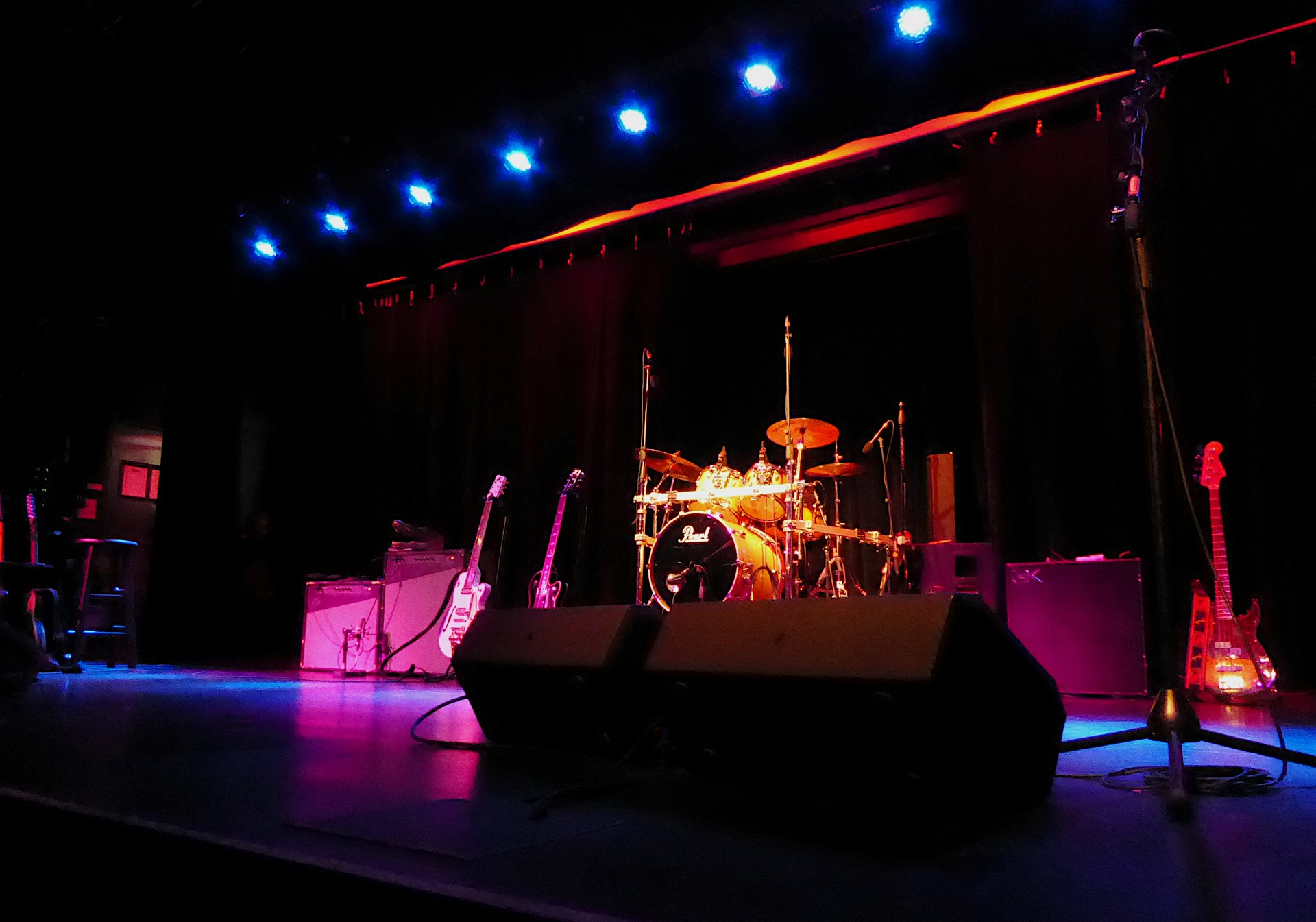 a stage with a set of musical instruments and a microphone