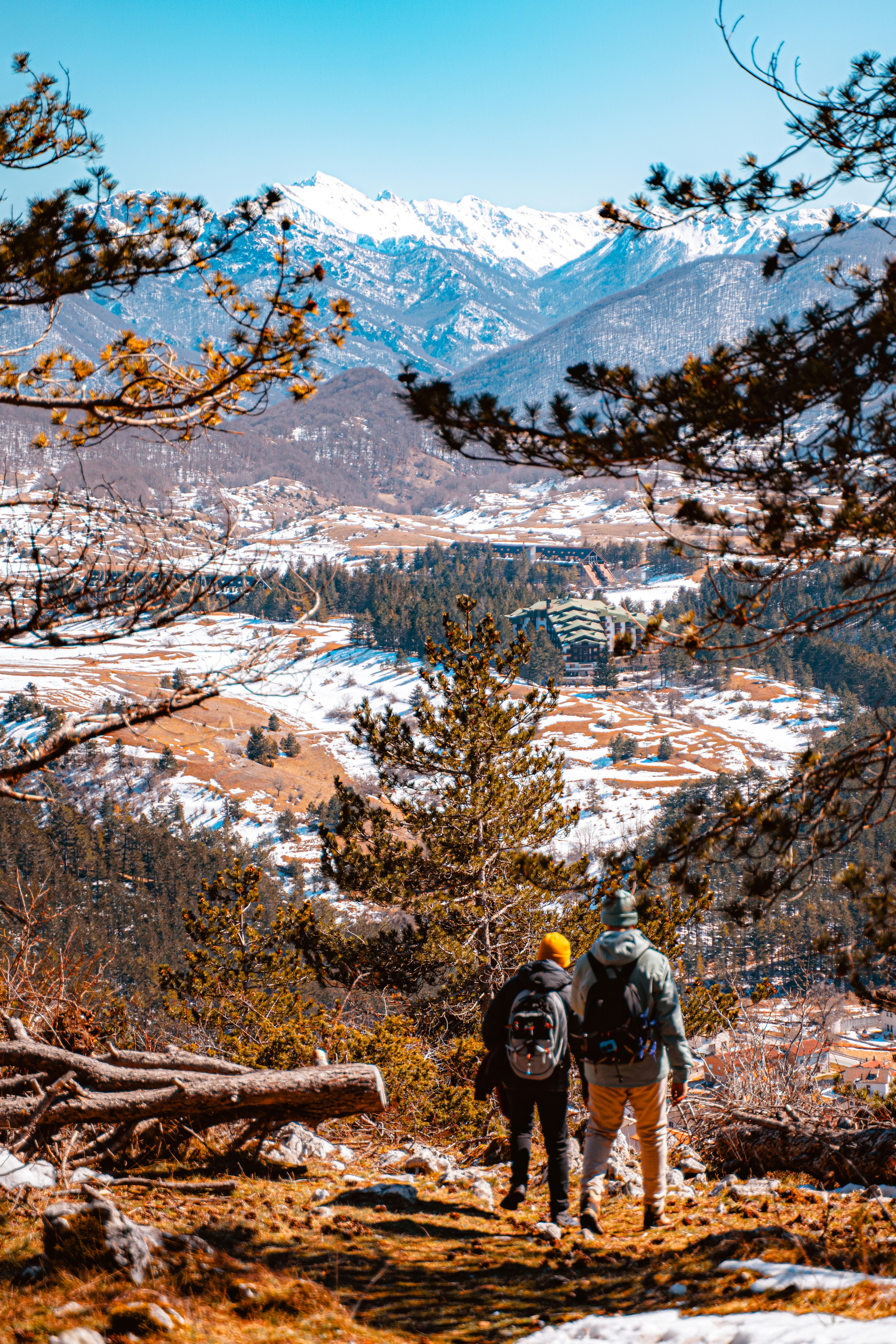 two people walking on a trail in the snow