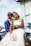 A joyful couple dancing at their wedding reception surrounded by friends and family.