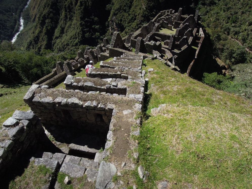 people walking on a stone bridge