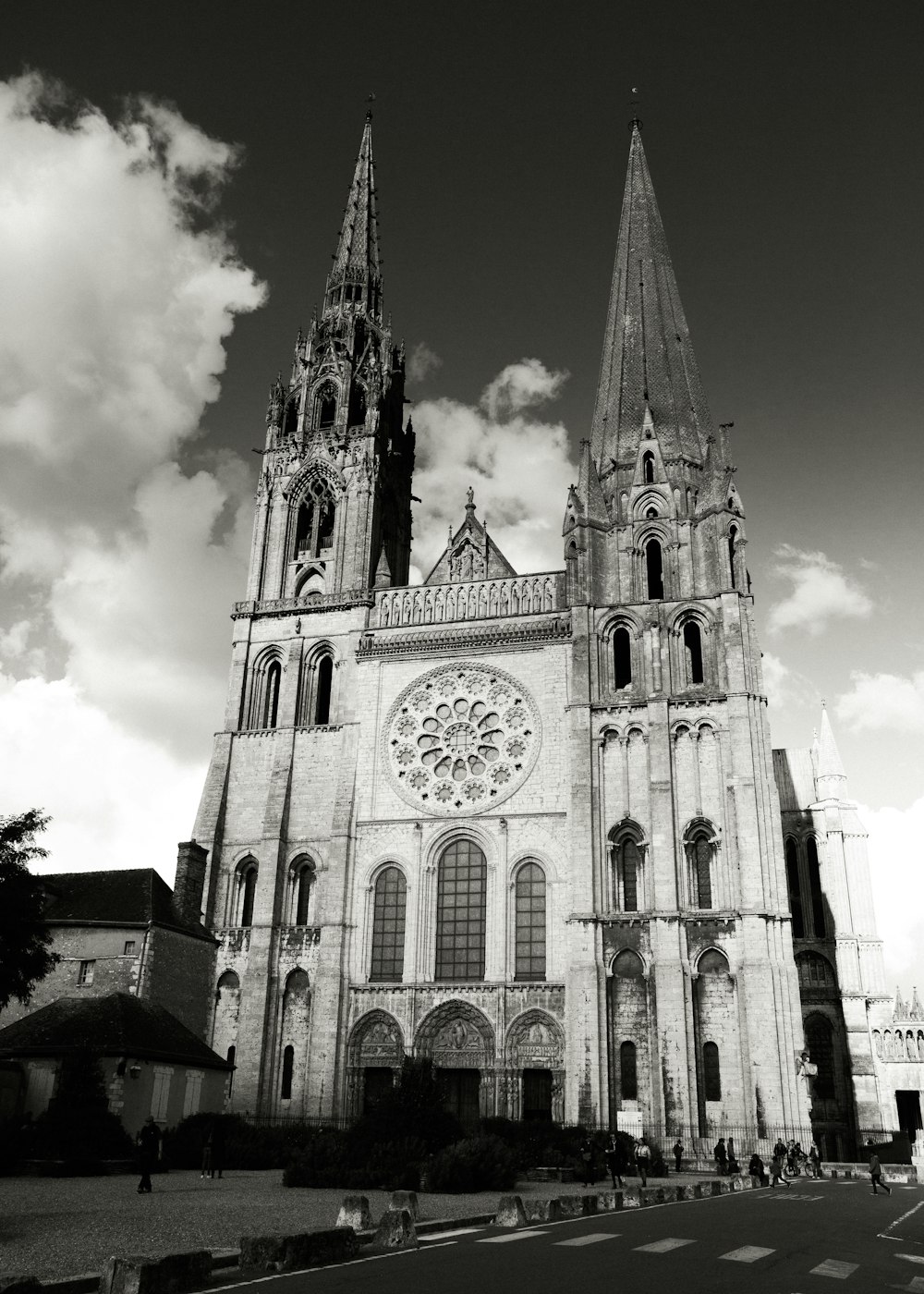 a large building with a clock on it with Chartres Cathedral in the background