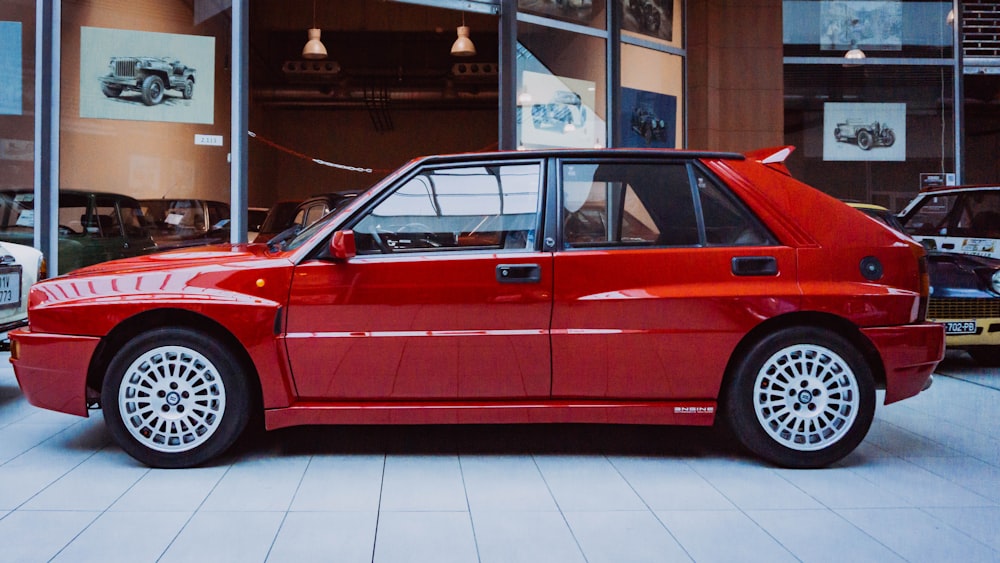 a red car parked in a showroom