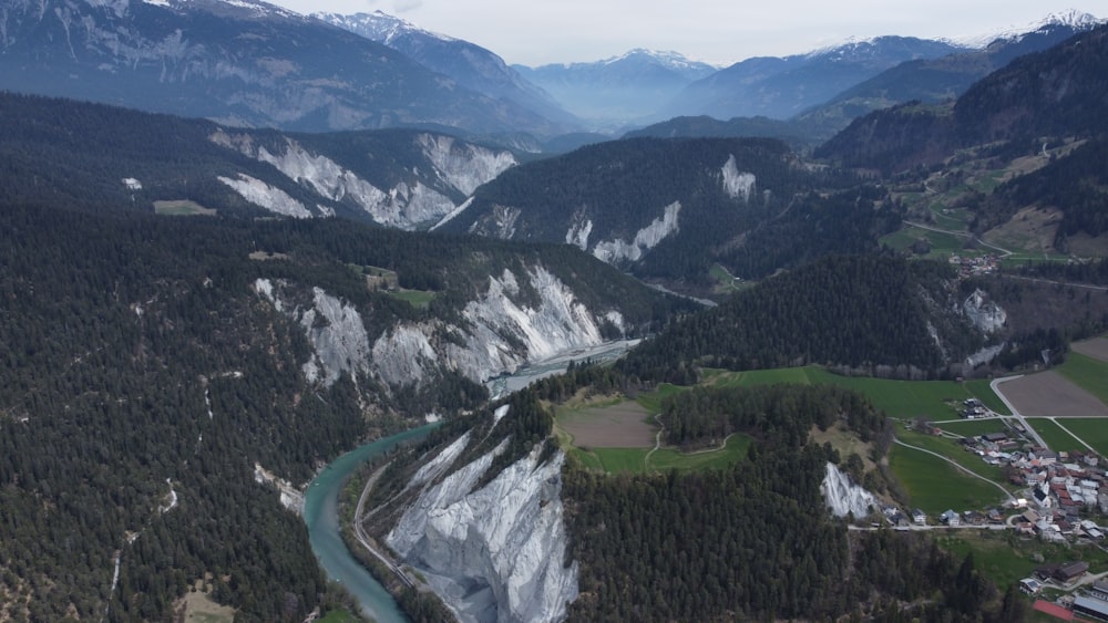 a winding road through a valley between mountains