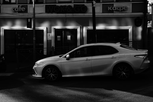 A sleek, compact car parked on a city street during the day.
