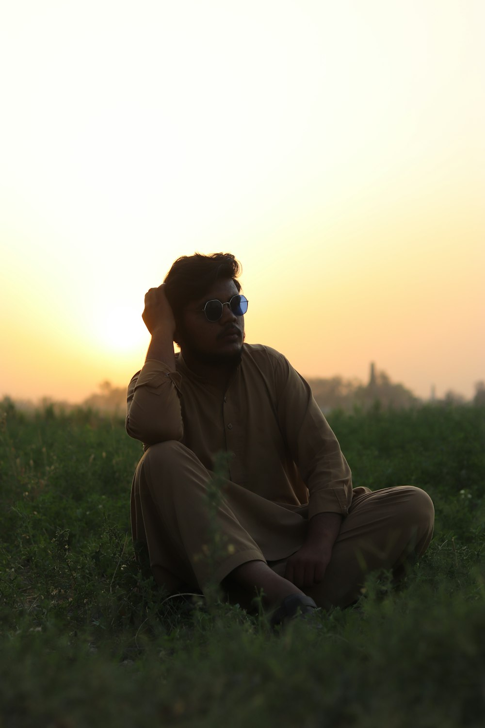 a man sitting in a field