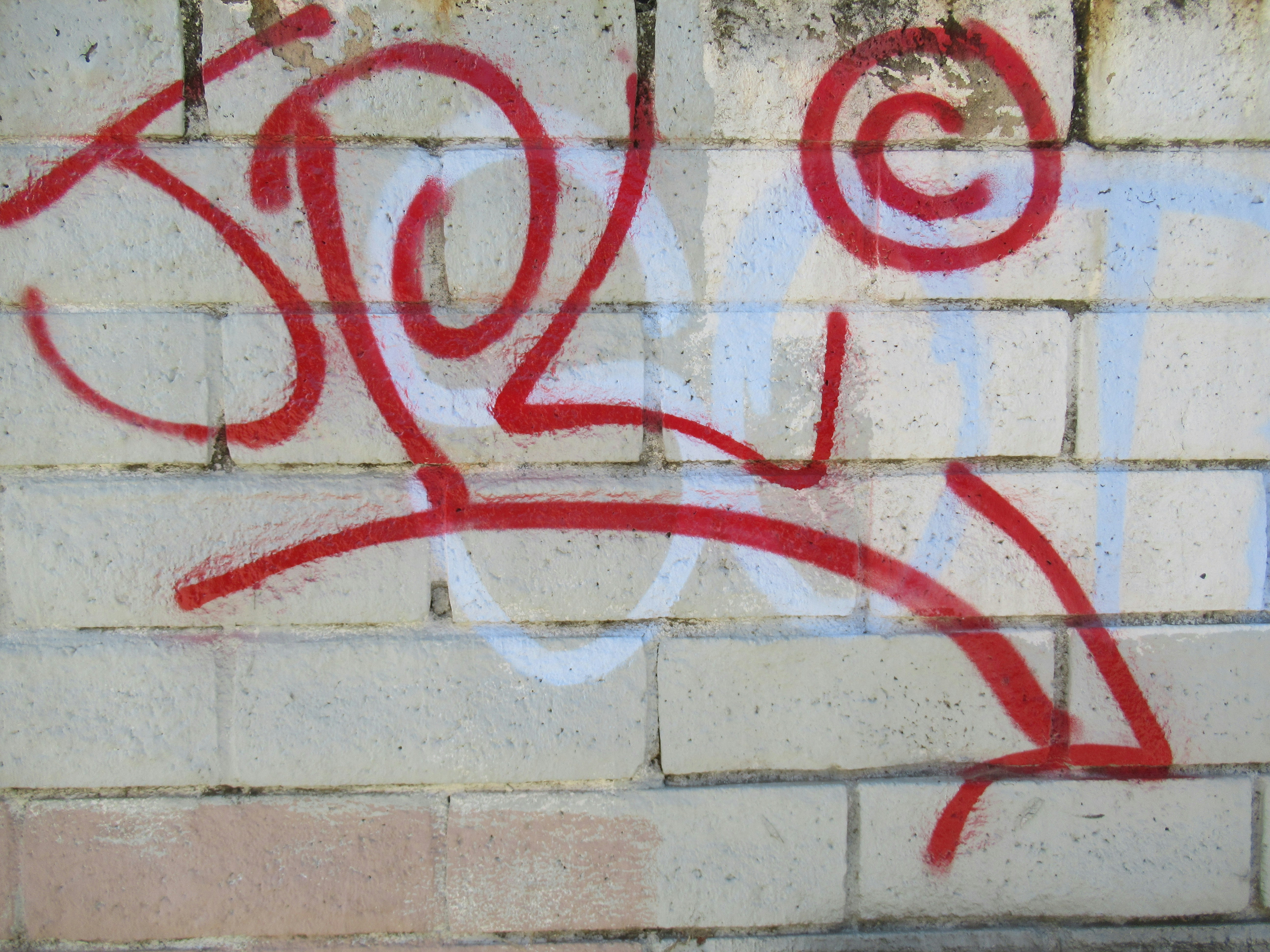 Red graffiti face on wall