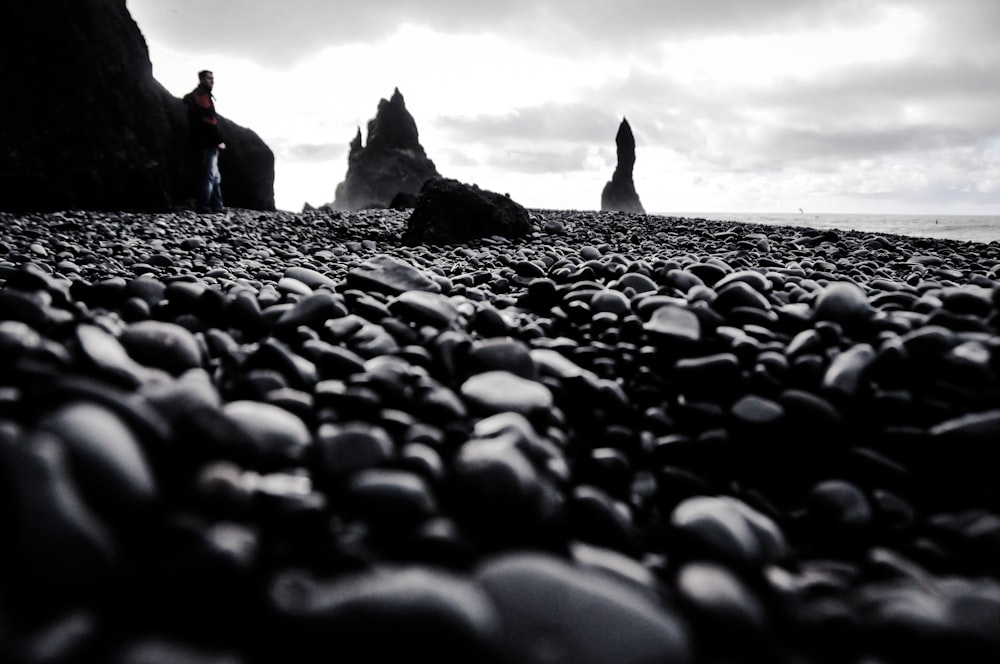 a person standing on a rocky beach