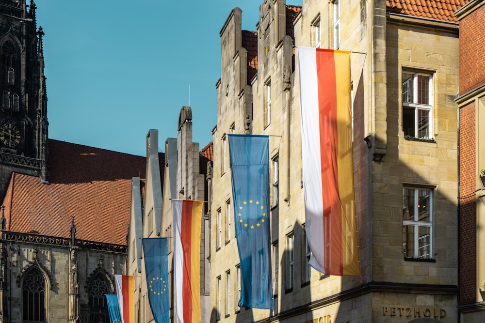 a row of flags on a building