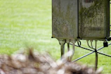 Outdoor installation of a buried box transformer surrounded by green landscape