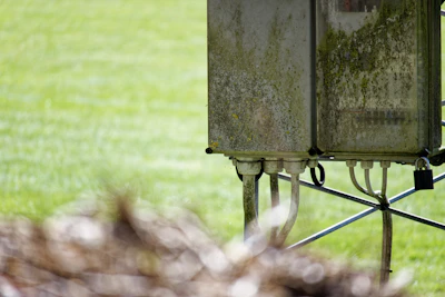 Outdoor installation of a buried box transformer surrounded by green landscape