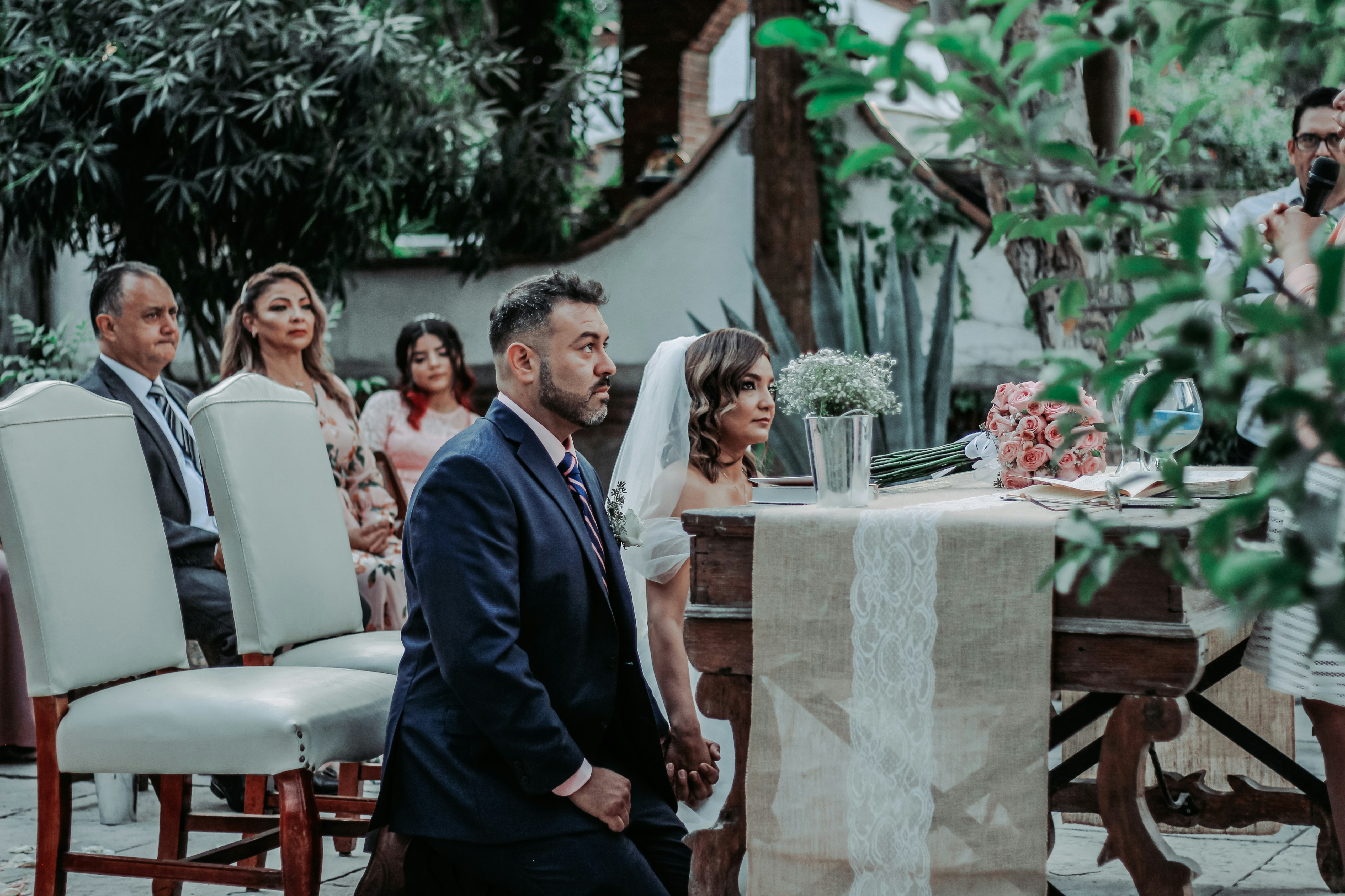 a man in a suit and tie standing next to a woman in a dress