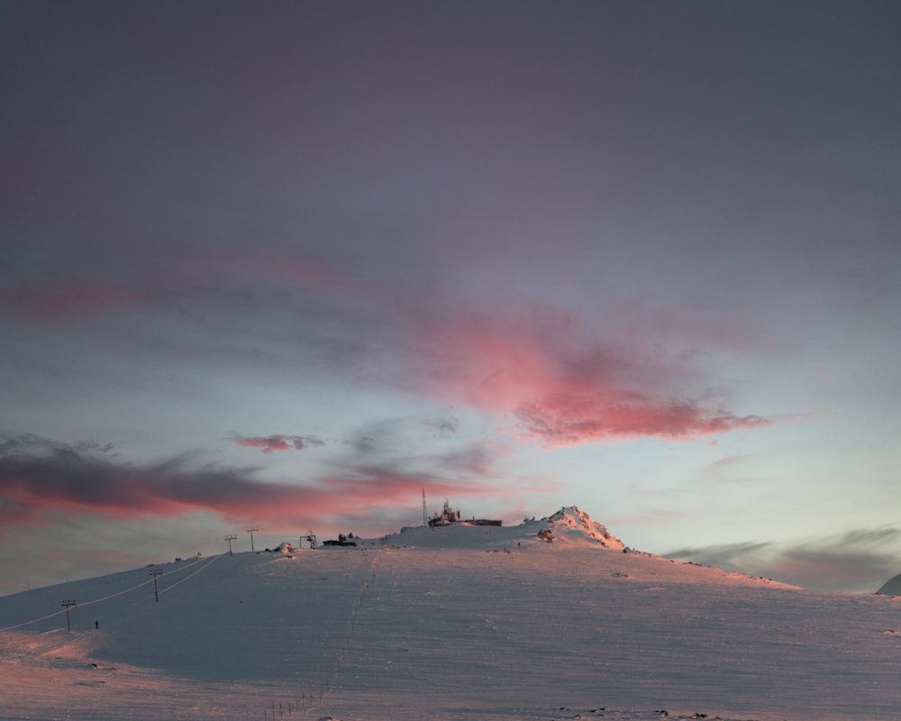 a snowy landscape with a mountain in the distance