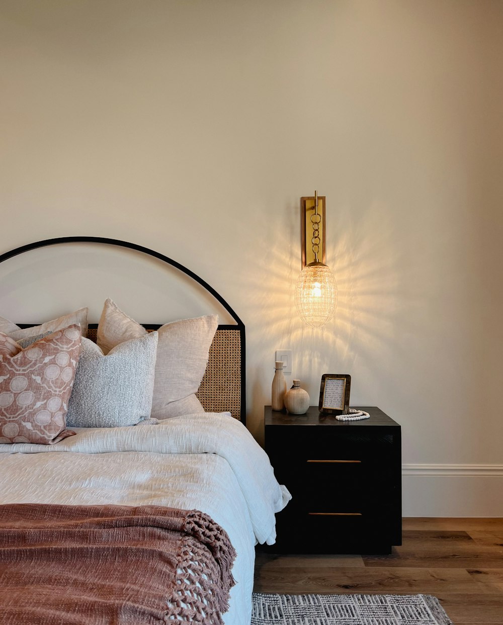 a bed with a lamp on the side