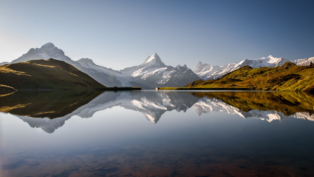 a body of water with mountains in the background