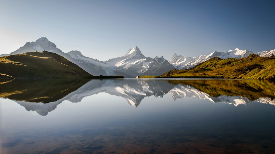 Bachalpsee alpine lake mirroring the surrounding snow-capped peaks