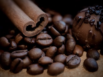 a close up of a chocolate truffle, a cinnamon coffee beans