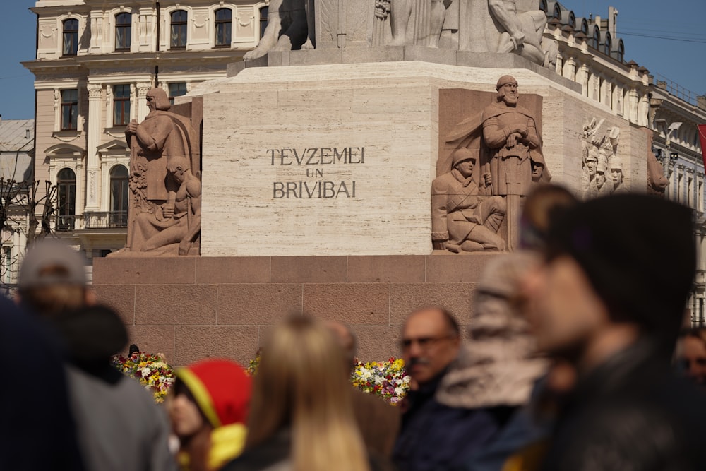 a group of people standing in front of a statue