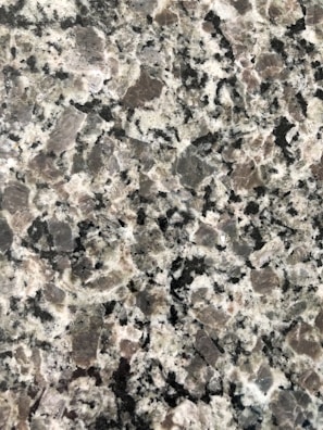 Various granite samples displayed on a showroom table.