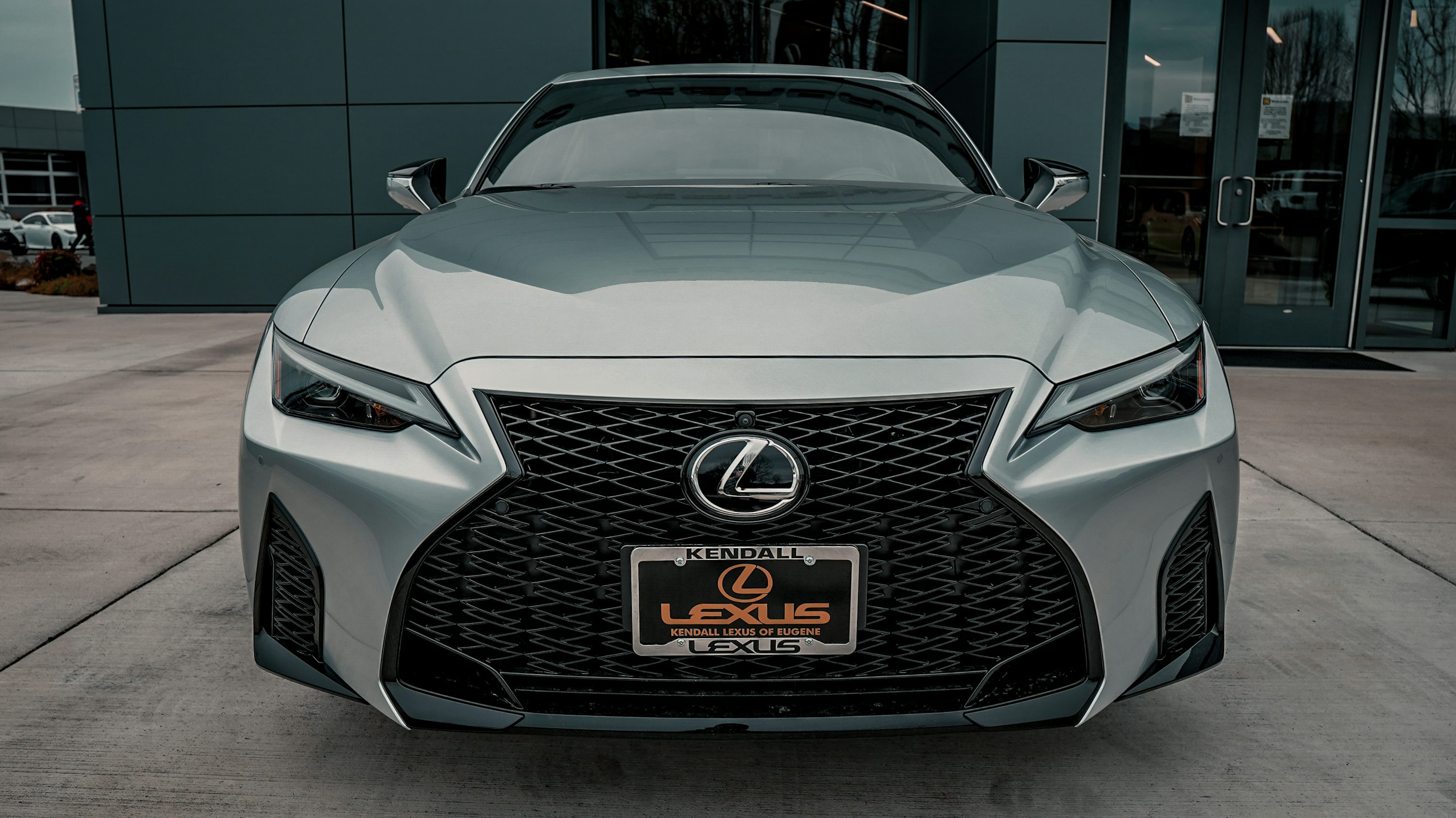 a silver car parked outside a building