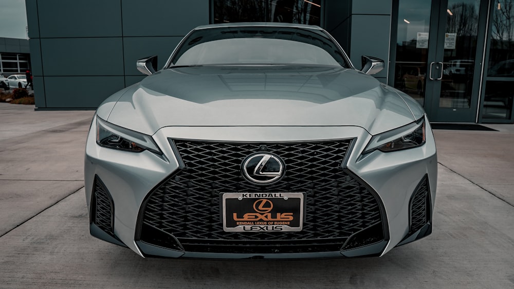 a silver car parked outside a building