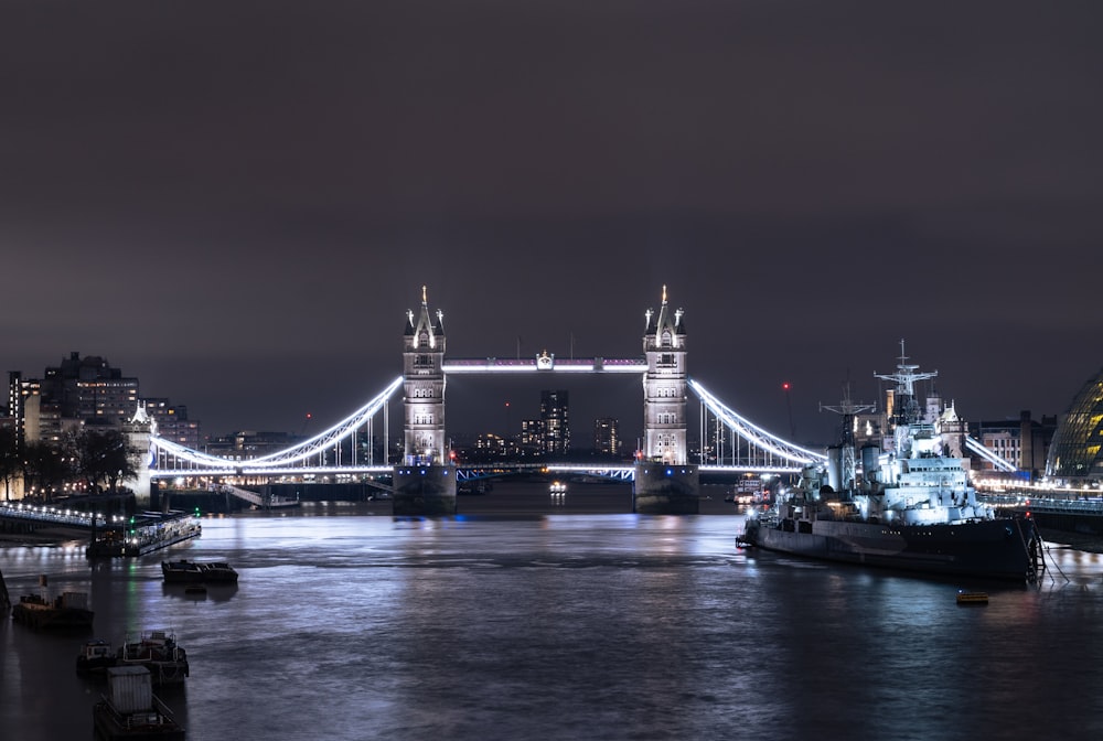 a bridge over a river with a large ship in the foreground