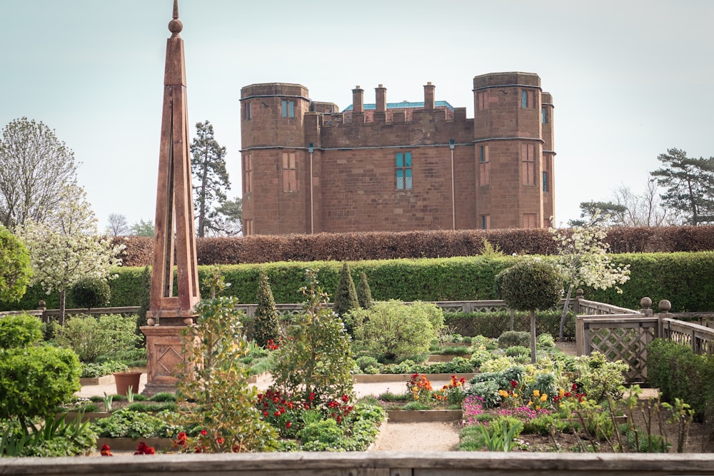 a large brick building with a tall tower in front of it