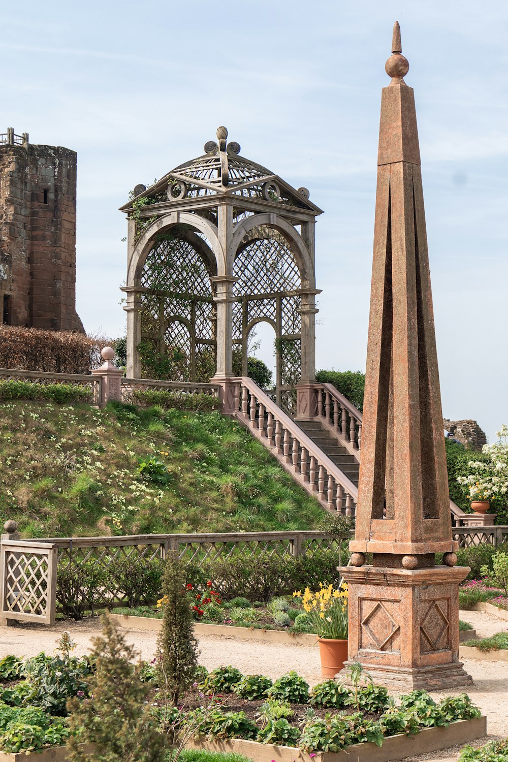 a tall tower in a garden