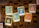 A collection of trading cards from a game called 'Toons and Towers' is spread out on a wooden surface. Each card features a colorful cartoon character and various stats like class, attack, and defense. The characters include a bird, a mushroom, a pig, a chameleon, a cat, and a large bird-like creature.