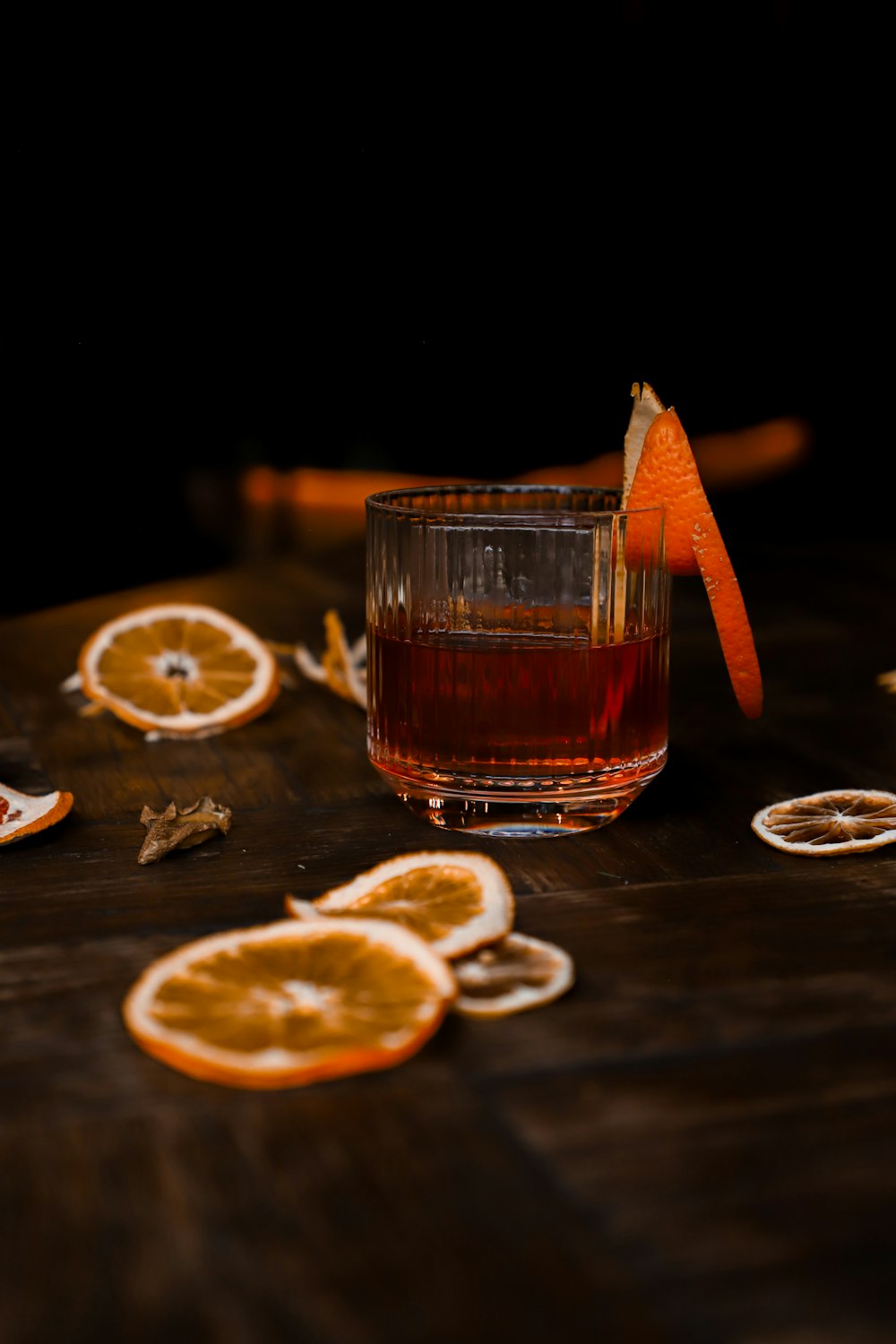 a glass of orange juice with a slice of orange and a slice of orange