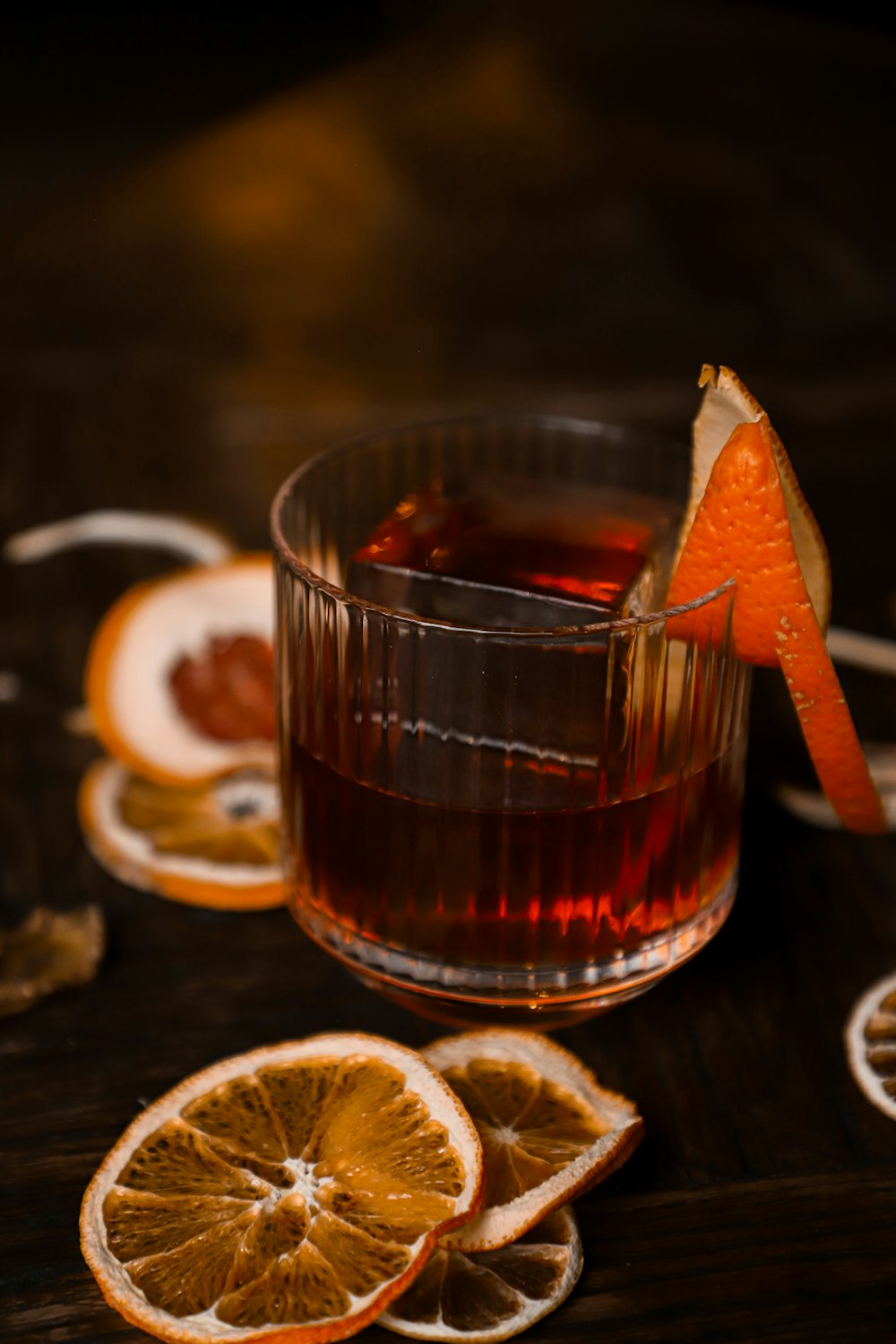 a glass of liquid with orange slices