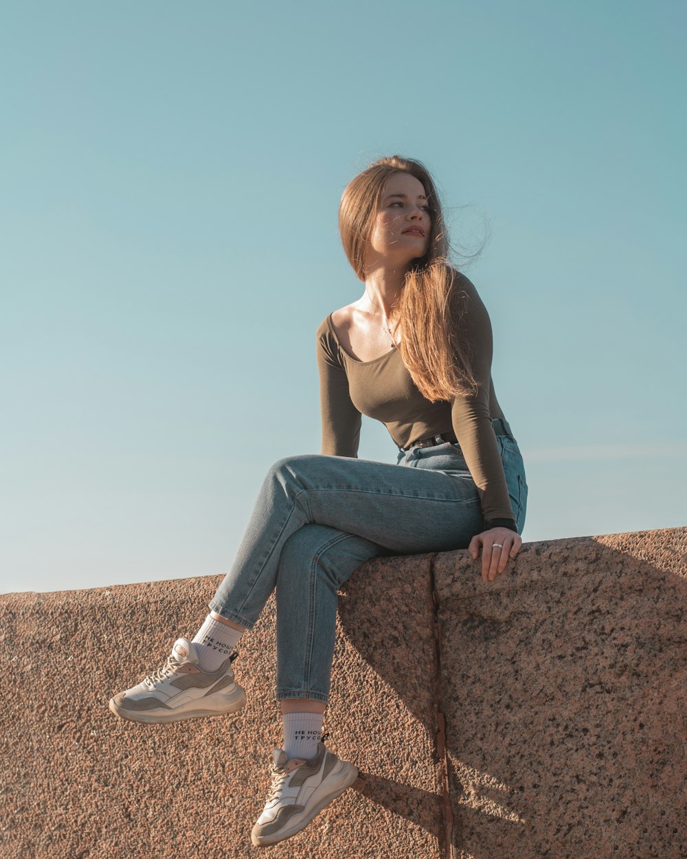 a person sitting on a rock