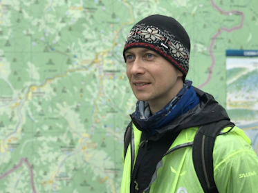 A traveler with a backpack looking at a map, ready for a new journey.