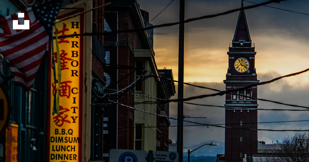 Seattle Clock Building A clock tower in a city photo – Free Seattle Image on Unsplash