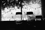Sunlight filtering through a window onto jars of homemade vinegar aging in clay pots.