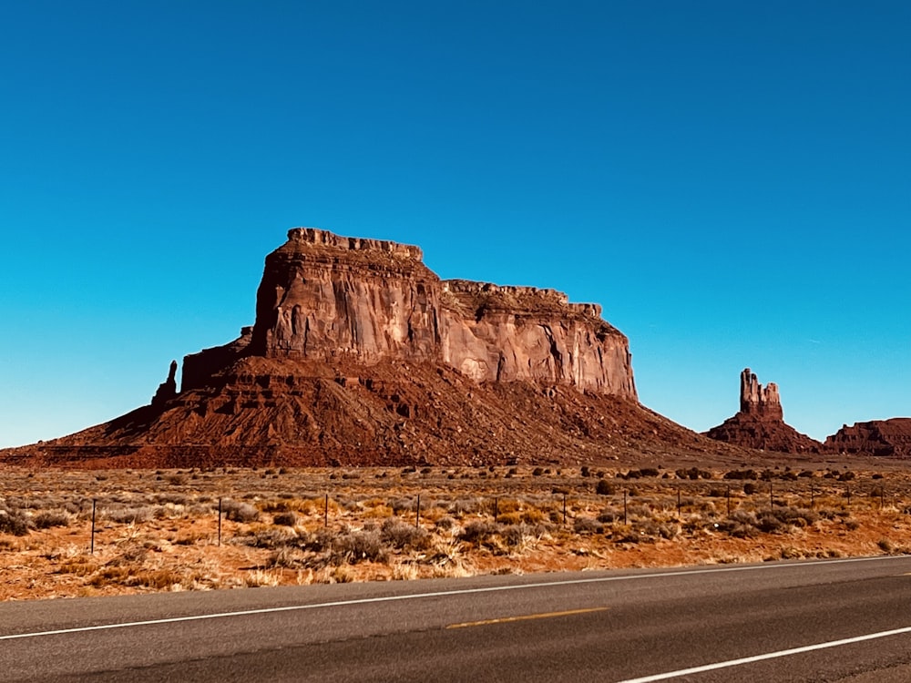 a road next to a rocky mountain