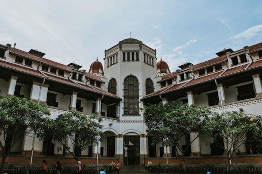 a large building with trees in front of it